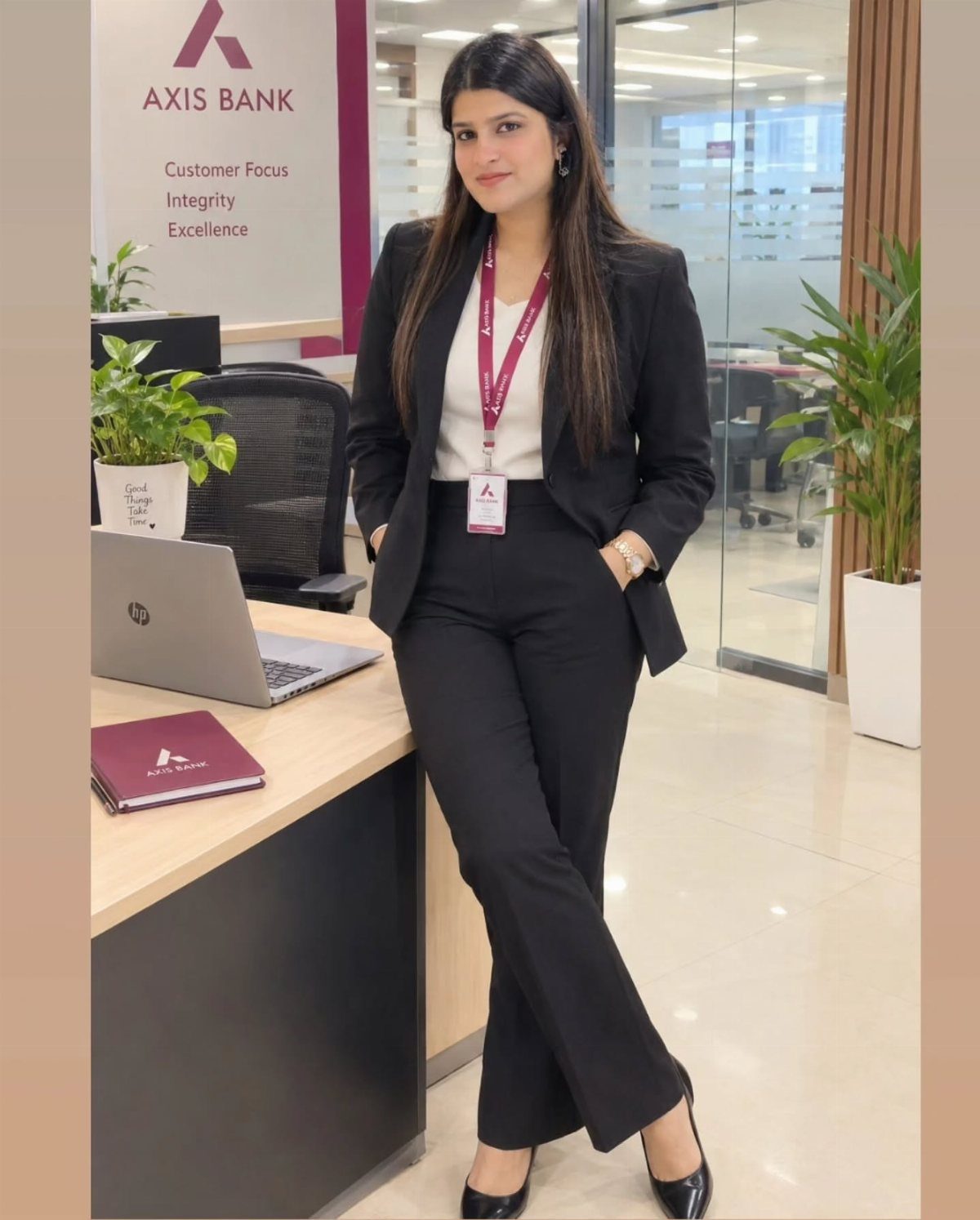 Woman in a professional black suit and white blouse standing in a bank office