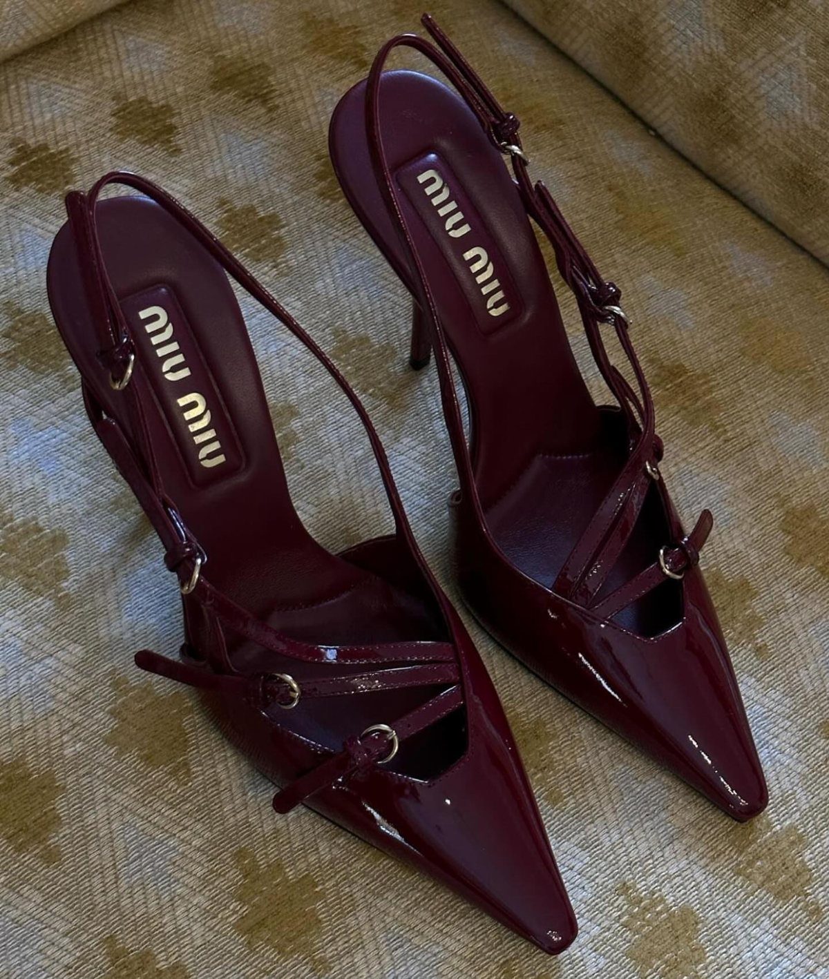 Burgundy patent leather miu miu high heels with pointed toes on patterned fabric